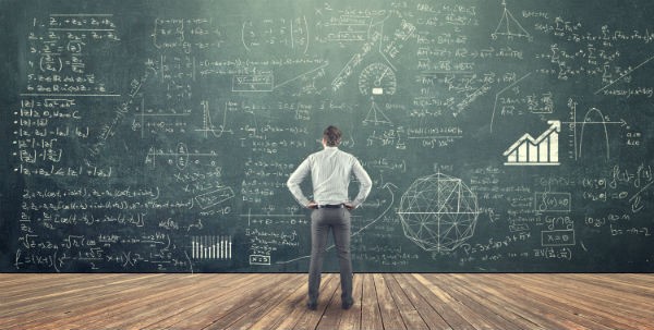 Man standing at chalkboard math equations