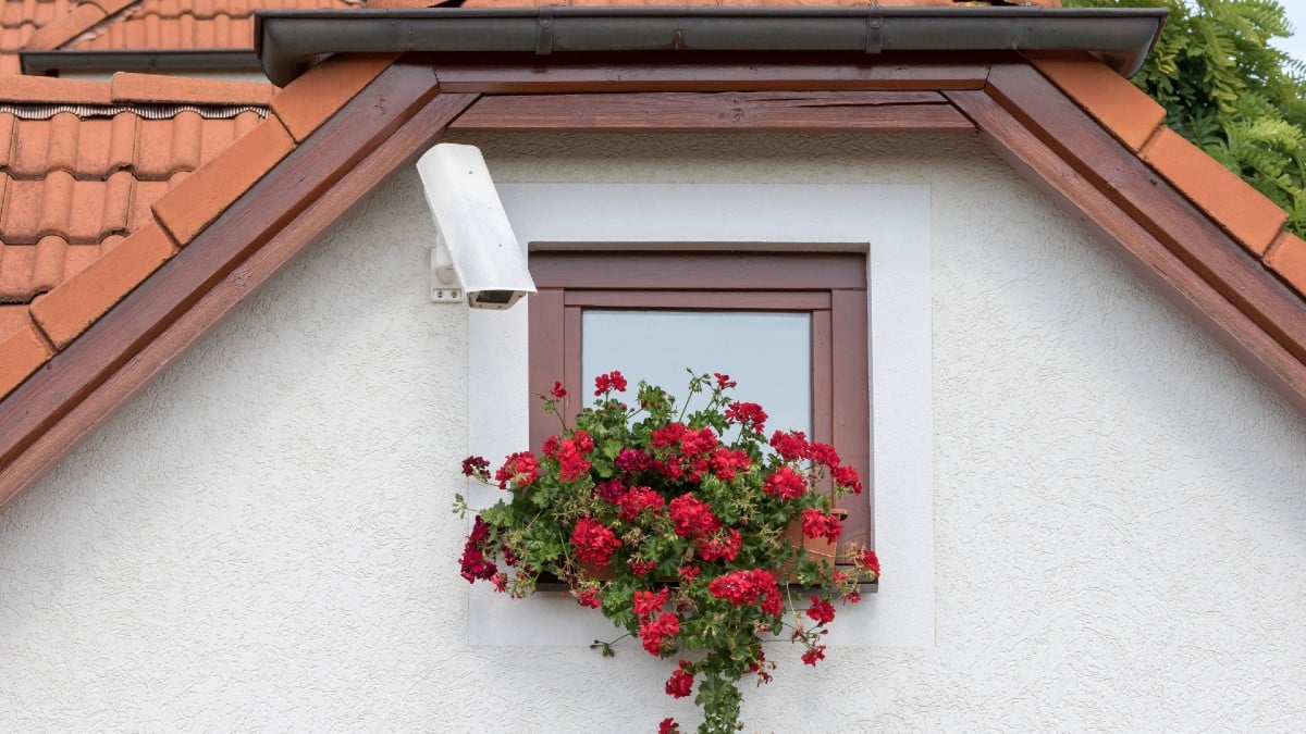 security camera on house with flowers
